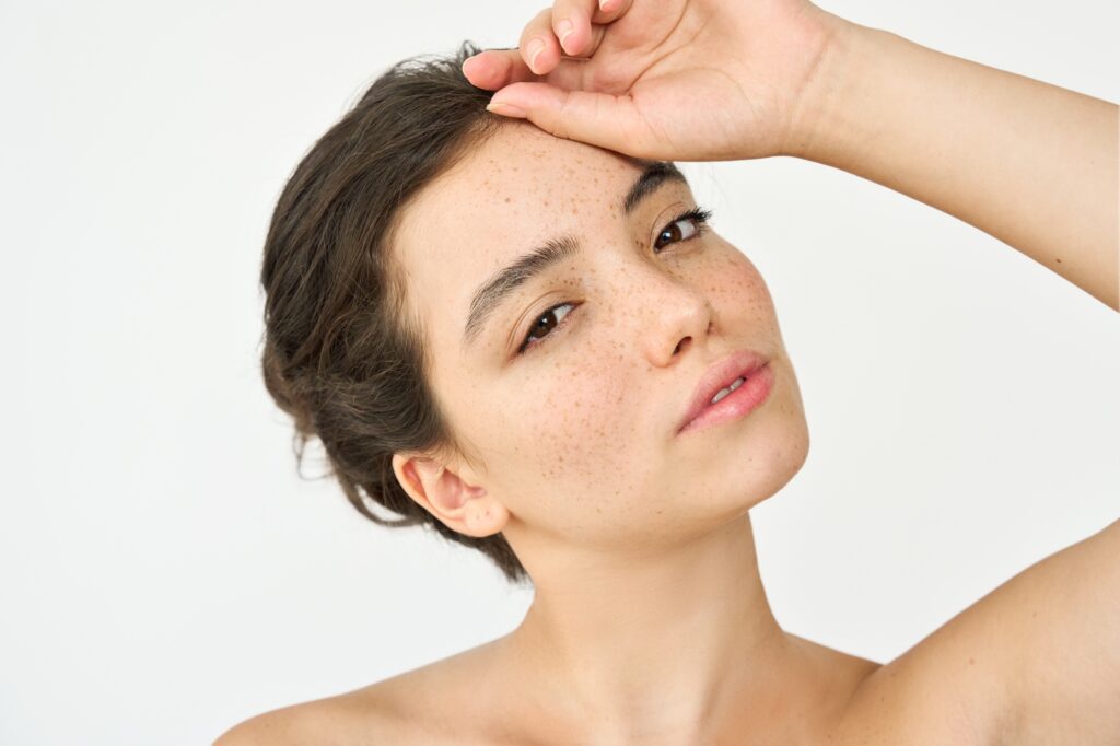 Aesthetic beauty portrait of Latin girl on white background. Skin care.