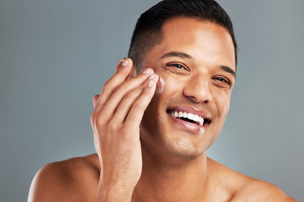 Happy man, face cream skincare and portrait moisturizer, healthy aesthetic and glowing skin on grey
